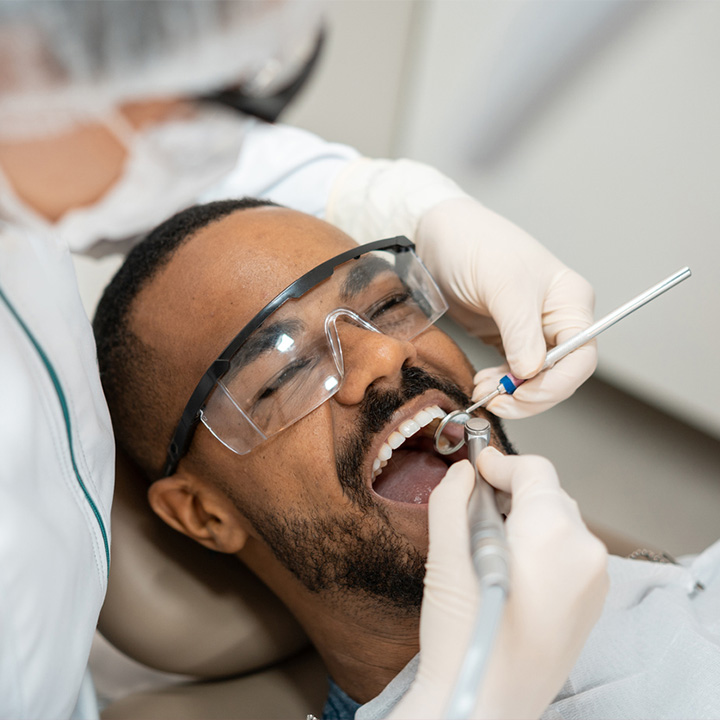 man at dentist receiving a dental checkup