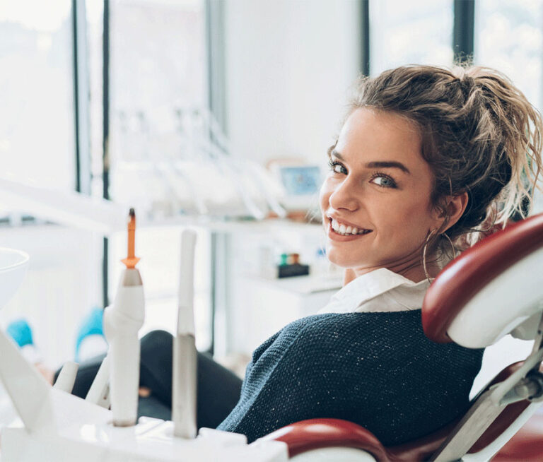 woman sitting in dental chair smiling