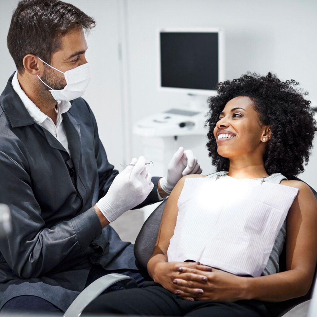 woman at dentist smiling at a male dentist